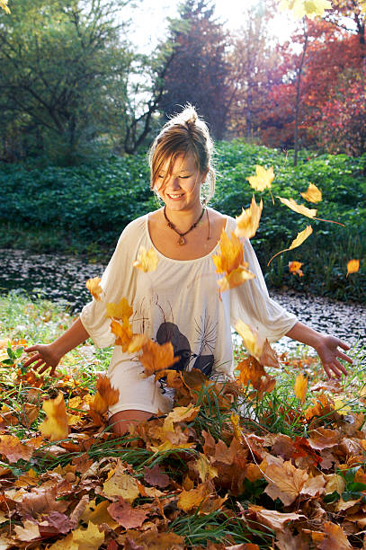 The girl throws leaves stock photo