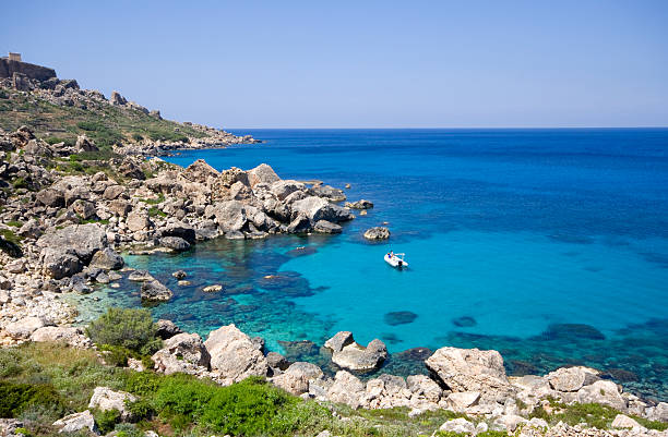 istock Small boat anchored in clear blue beach alone 106476611