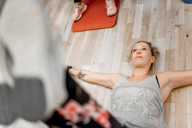 istock Young woman exercising at the gym 1064768430