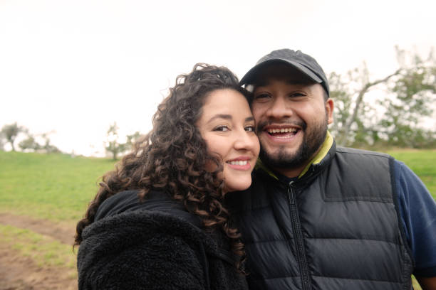 istock Millennial Hispanic Couple Looking at Camera Outdoors in Upstate New York 1064771336