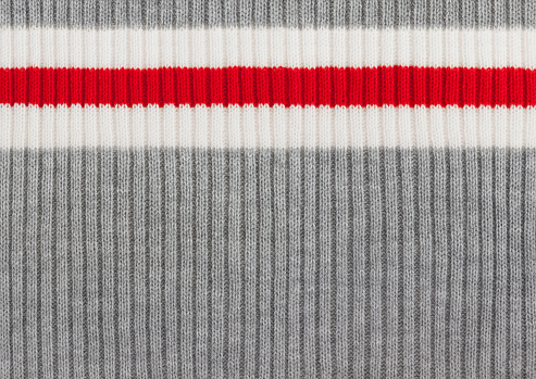 Gray, White and Red Striped Knit Wool Background