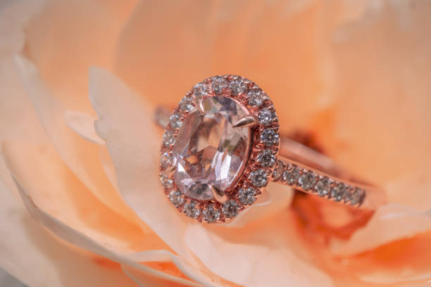 istock pink diamond ring on rose flower background 1064785738