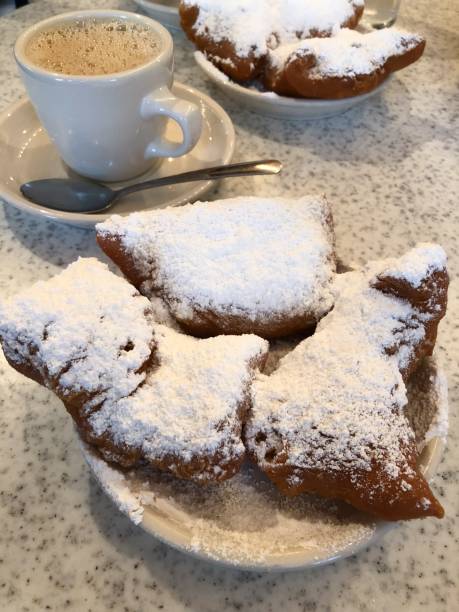 New Orleans Cafe du monde beignets and chicory coffee in the French quarter. beignet stock pictures, royalty-free photos & images