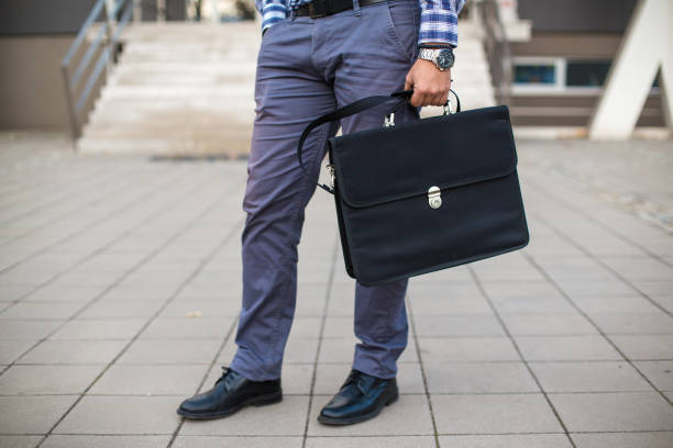 istock Businessman with briefcase in hand 1064789488