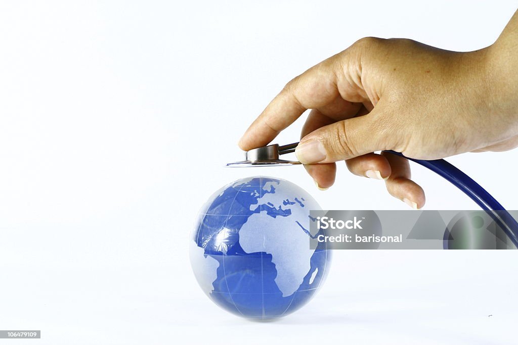 Hand holds stethoscope up to world globe Global Healthcare Global Healthcare World Health Organization Stock Photo