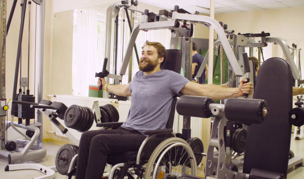 istock Disabled man in wheelchair doing hand exercises 1064795430