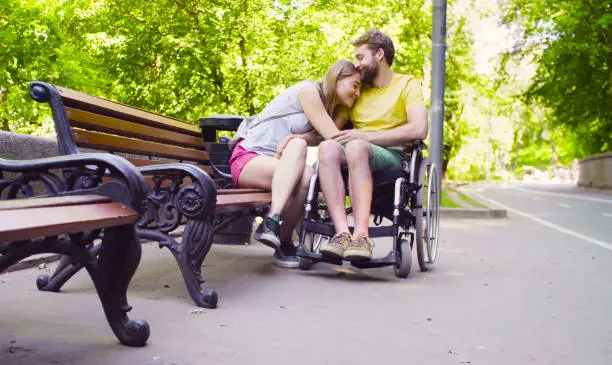 Photo of Young disable man with his wife in the park