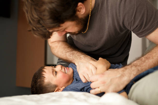 istock Parents playing with son and daughter on bed 1064799560
