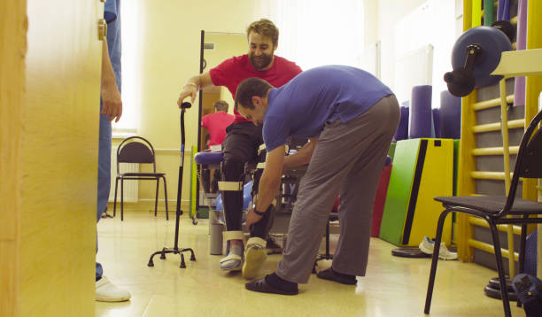 istock Invalid in orthosis ready to walk with support of two walking cane 1064799982