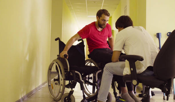 istock Young disable man changing the bench to wheelchair 1064801284