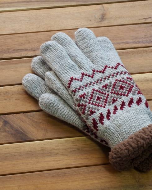 istock Wooden background and winter gloves 1064801338