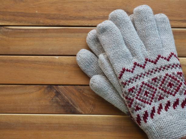 istock Wooden background and winter gloves 1064801344