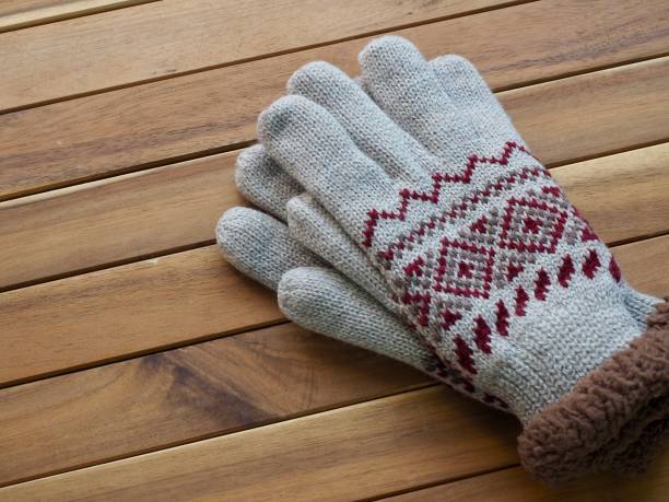 istock Wooden background and winter gloves 1064801346