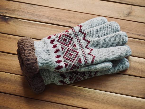 istock Wooden background and winter gloves 1064801364