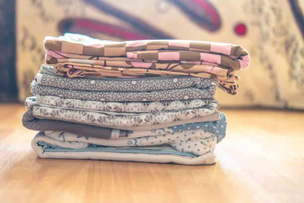 istock stack of textile sheets blankets on a wooden shelf f 1064803704