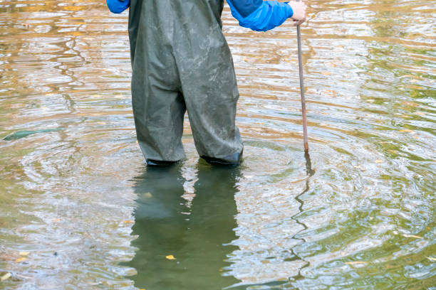istock man going ford through the river wearing protective uniform f 1064803728