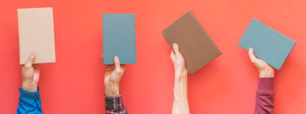 istock many hands hold multiple books isolated on color surface concept f 1064805436