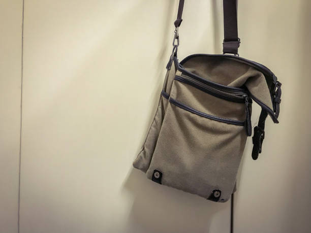 istock Brown shoulder bag hang on white bathroom door 1064811986