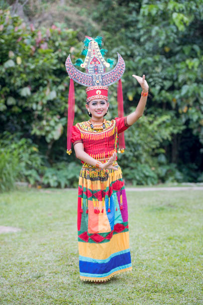 Zhyta,24 the Toraja traditional dancer pose for camera with colourful traditional costume. stock photo