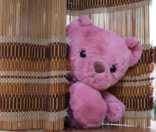 istock Cute teddy bear on wood background 1064816252