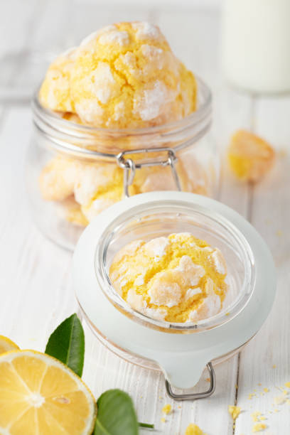 istock Cracked Lemon cookies in small glass jar, on white background , vertical composition 1064820248