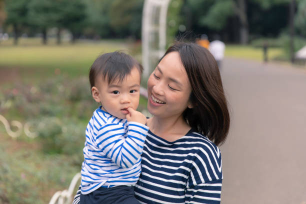 istock Happy young mother and son in public park 1064821802