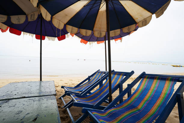 istock table chairs and umbrellas on the beach 1064828098