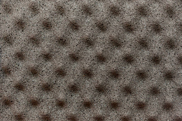 istock Gray background of foam material with pyramidal protrusions on the surface used for vibration and noise insulation in recording studios or cars 1064830018