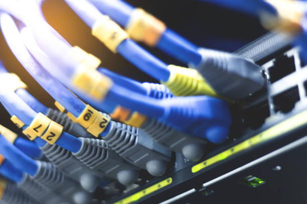 istock network cables connected in network switches - Data Center Concept. selected focus and soft focus 1064832586