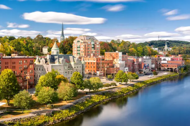 Augusta skyline on a sunny afternoon (long exposure for smooth sky and water). Augusta is the state capital of the U.S. state of Maine and the county seat of Kennebec County
