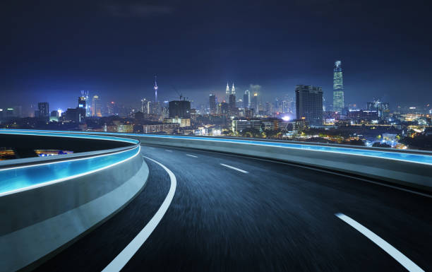 istock Highway overpass motion blur with city background 1064838802