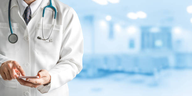 istock Male doctor using mobile phone at hospital. 1064841392