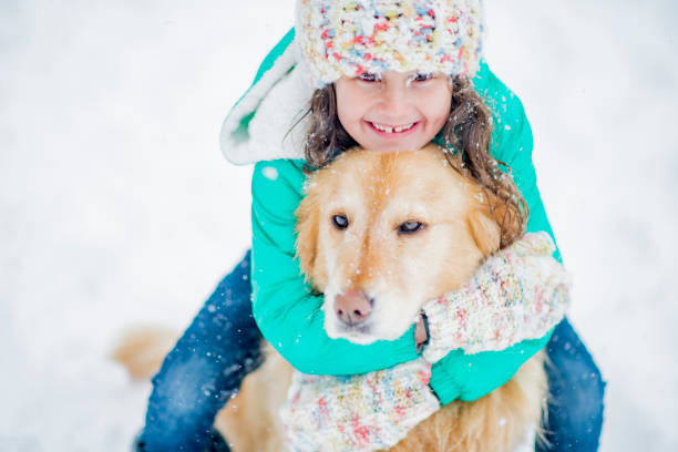 istock Girl and dog winter hug 1064843582