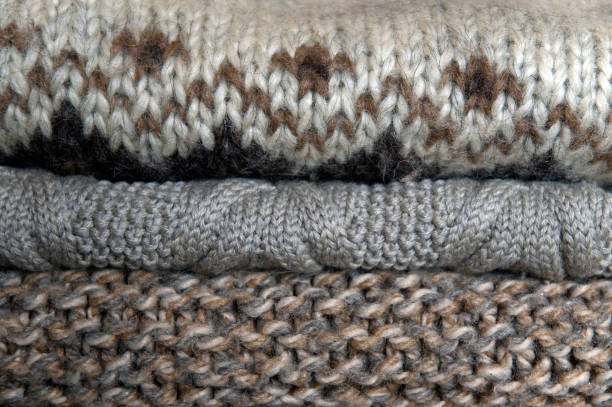 istock knitted woolen jumpers stacked in wardrobe 1064845074