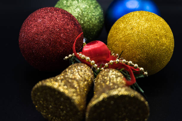 istock Golden bell and colorful christmas baubles. 1064845892