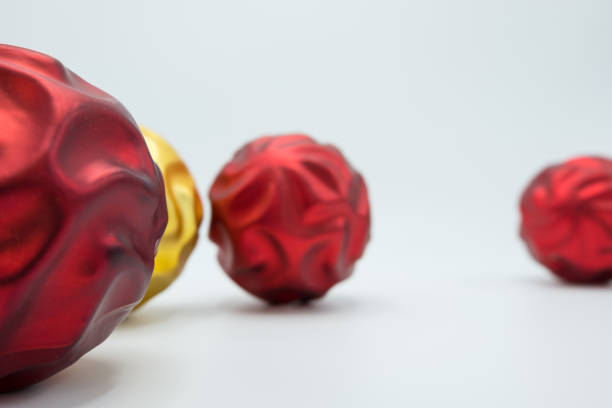 istock Red and golden wavy christmas tree balls on white. 1064847484