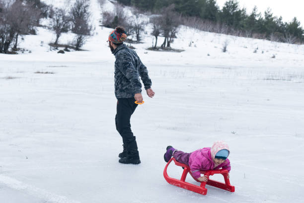 istock Father with kids sledding 1064849316