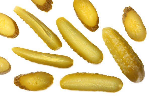 istock sliced marinated pickled cucumbers isolated on white background. top view 1064866242