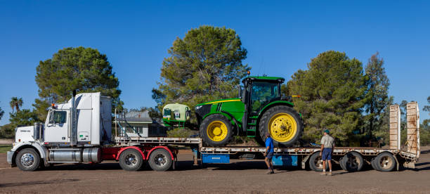 green tractor on trailer