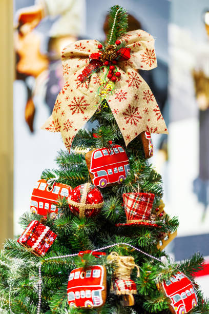 istock Fir tree decorated with gingerbread in shape of double decker bus and fabric balls for Christmas and New Year celebration. 1064868408