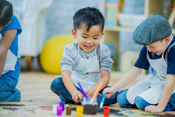 istock Kindergarten boys painting and playing 1064869270