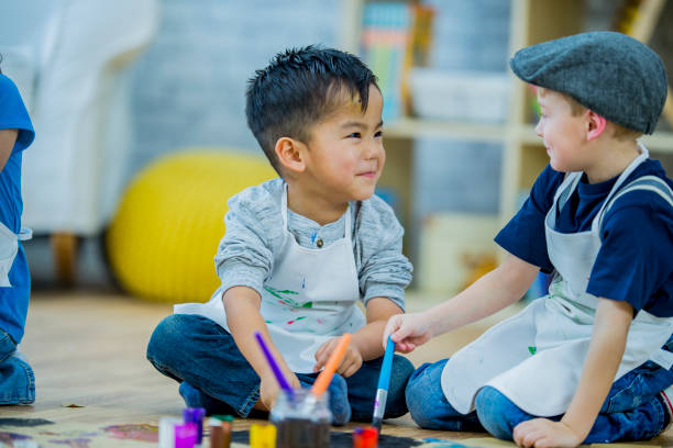 istock Cute preschool boys painting 1064869302