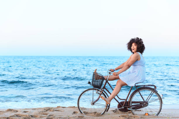 istock African Woman riding bicyle on sand 1064870950