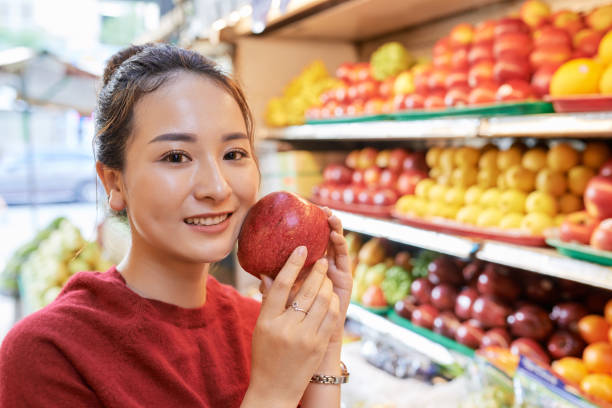 istock Asian woman with red apple 1064873592