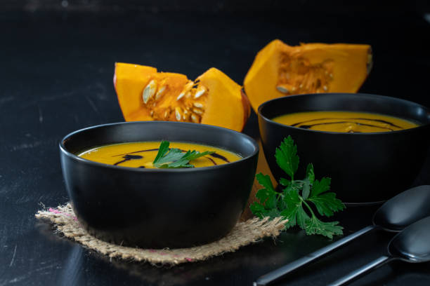 warming up soup with pumpkin in autumn stock photo