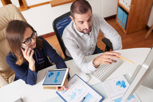 istock Coworkers discussing report 1064875690