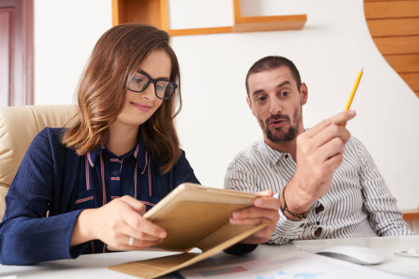 istock Cheerful business lady reading report on tablet 1064875762