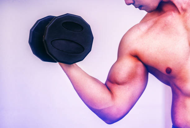 istock Muscular man bodybuilder training with dumbbells.Muscular man bodybuilder training with dumbbells. 1064883866