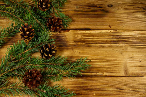 istock Christmas composition with fir tree branches and cones on wooden background. Top view, copy space 1064885004