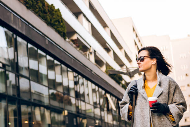 istock Walking through the city with takeaway coffee. 1064887558